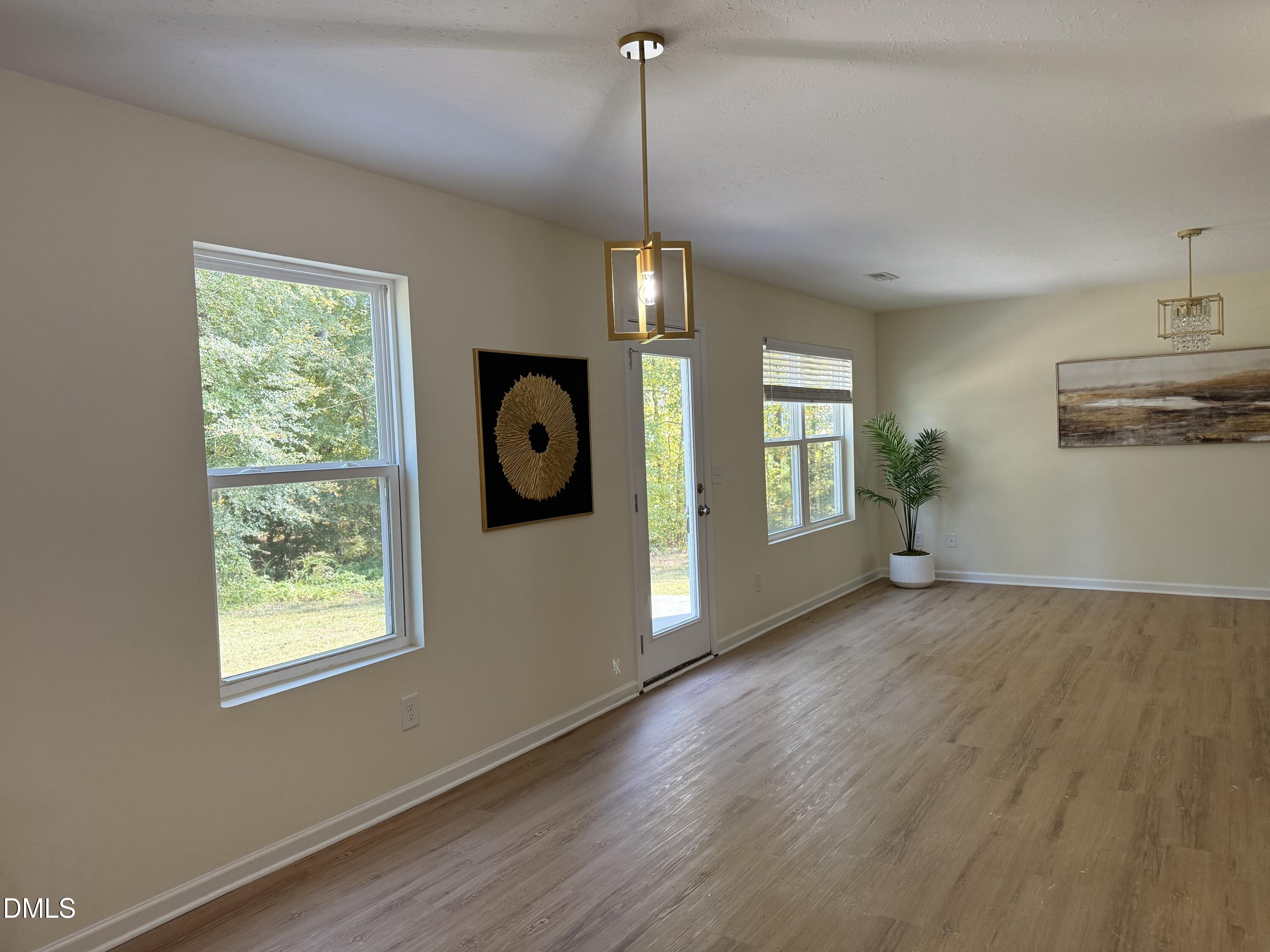 62 West Boulder Road Henderson, NC 27537 - Photo 9 of 34 a view of an empty room with window and wooden floor