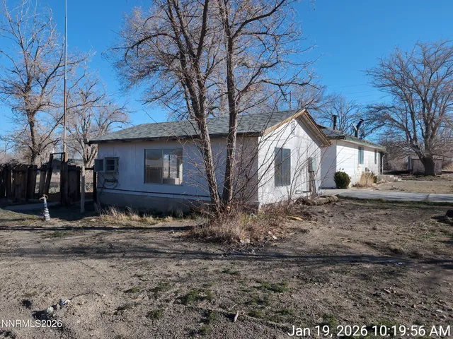 a view of a house with a yard covered with snow