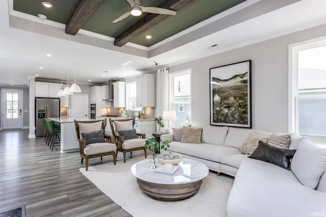 a living room with furniture and a dining room