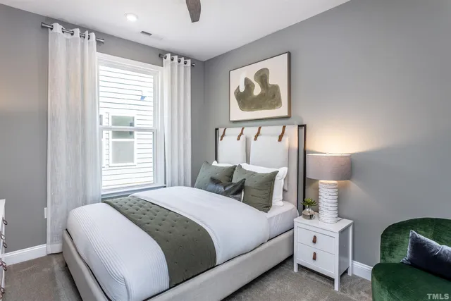 a bedroom with a bed and a painting on the wall