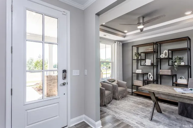 a living room with furniture a window and a table