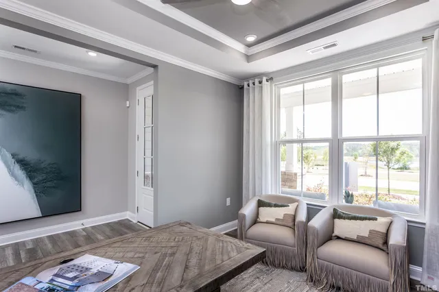a bedroom with furniture and a flat screen tv