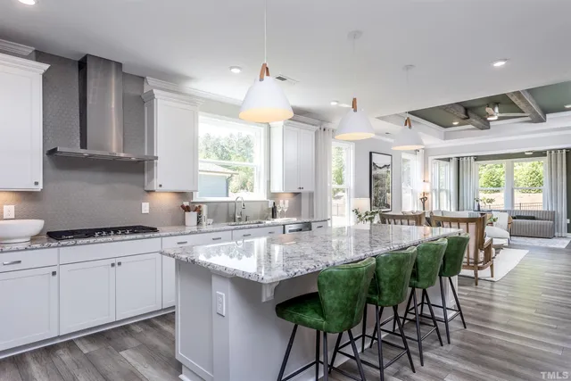 a kitchen with sink a stove and chairs