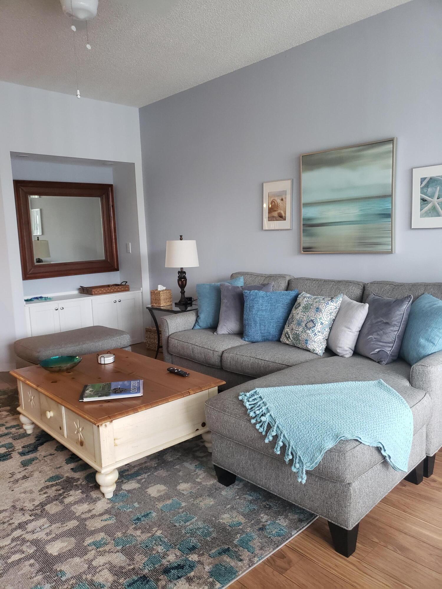 6021 Southeast Landing Way, Unit BLDG 2 #2 Stuart, FL 34997 - Photo 11 of 35 a living room with furniture and a couch