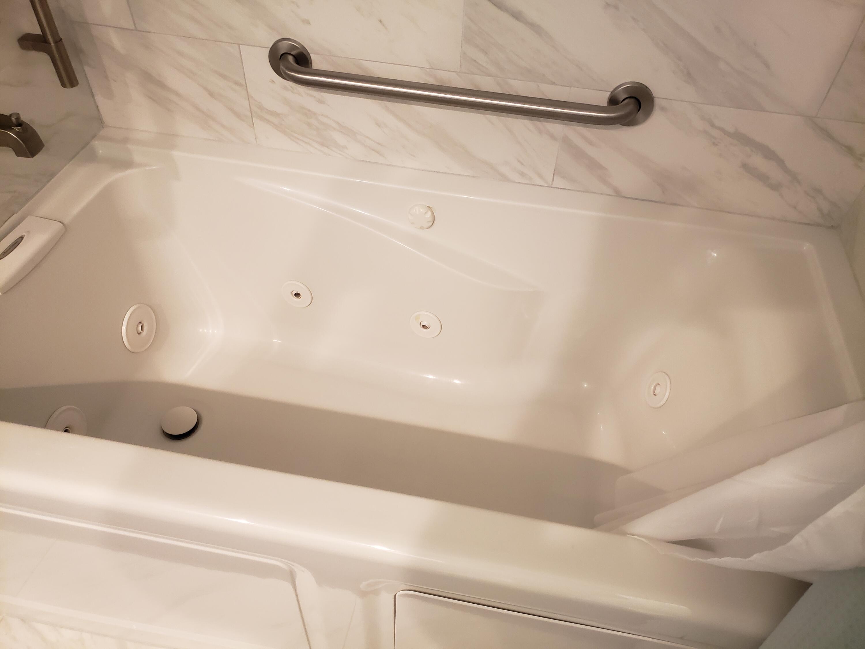 6021 Southeast Landing Way, Unit BLDG 2 #2 Stuart, FL 34997 - Photo 13 of 35 a bathroom with a shower and a bath tub