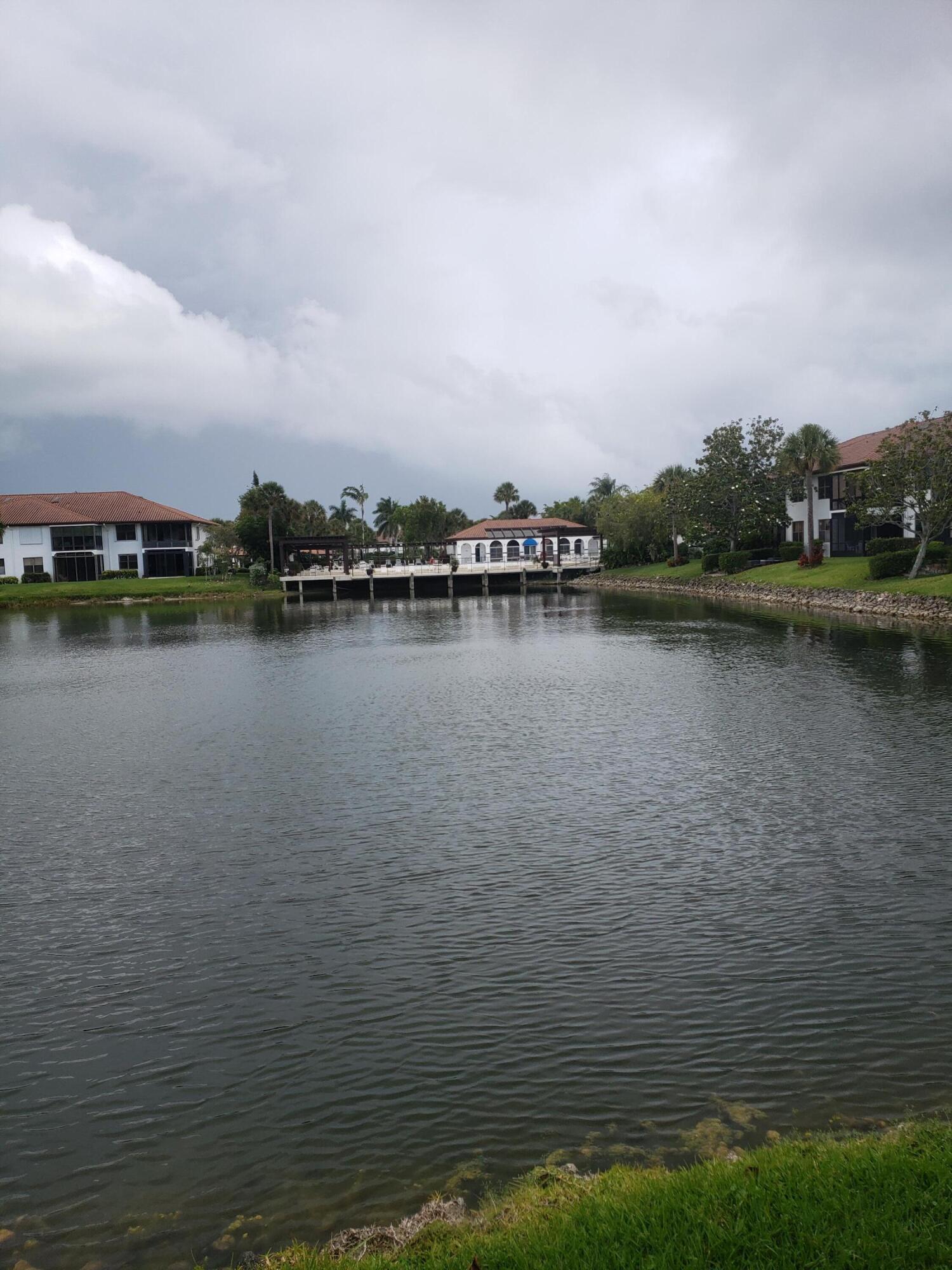 6021 Southeast Landing Way, Unit BLDG 2 #2 Stuart, FL 34997 - Photo 14 of 35 a view of a lake with houses in back