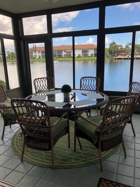 6021 Southeast Landing Way, Unit BLDG 2 #2 Stuart, FL 34997 - Photo 16 of 35 a view of a dining room with furniture window and outside view