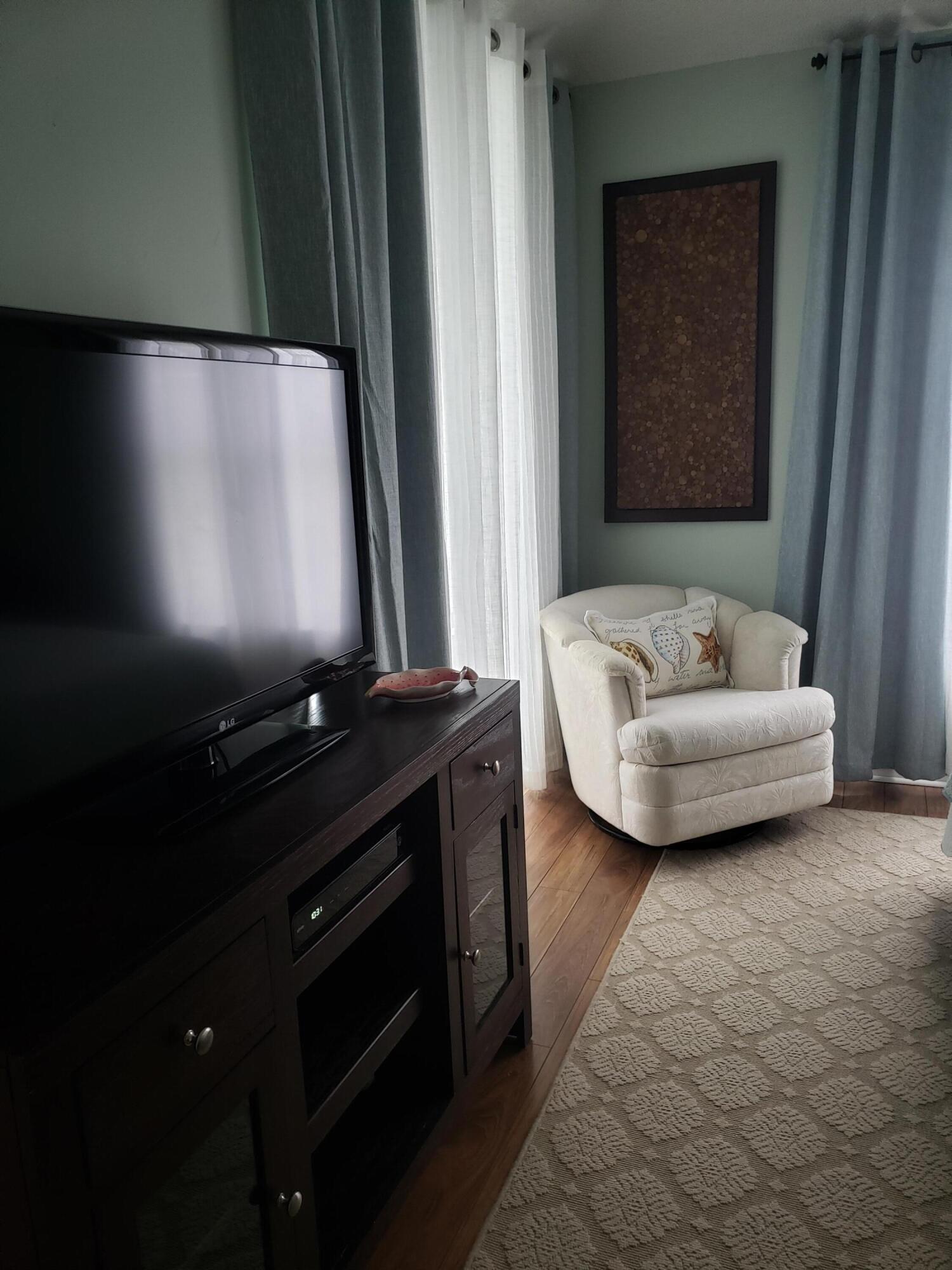 6021 Southeast Landing Way, Unit BLDG 2 #2 Stuart, FL 34997 - Photo 27 of 35 a bathroom with a sink and a mirror