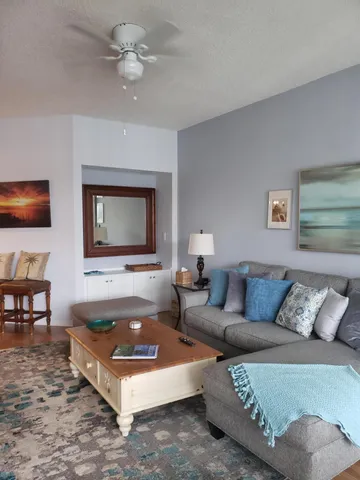 a view of a living room with a sink and wooden floor