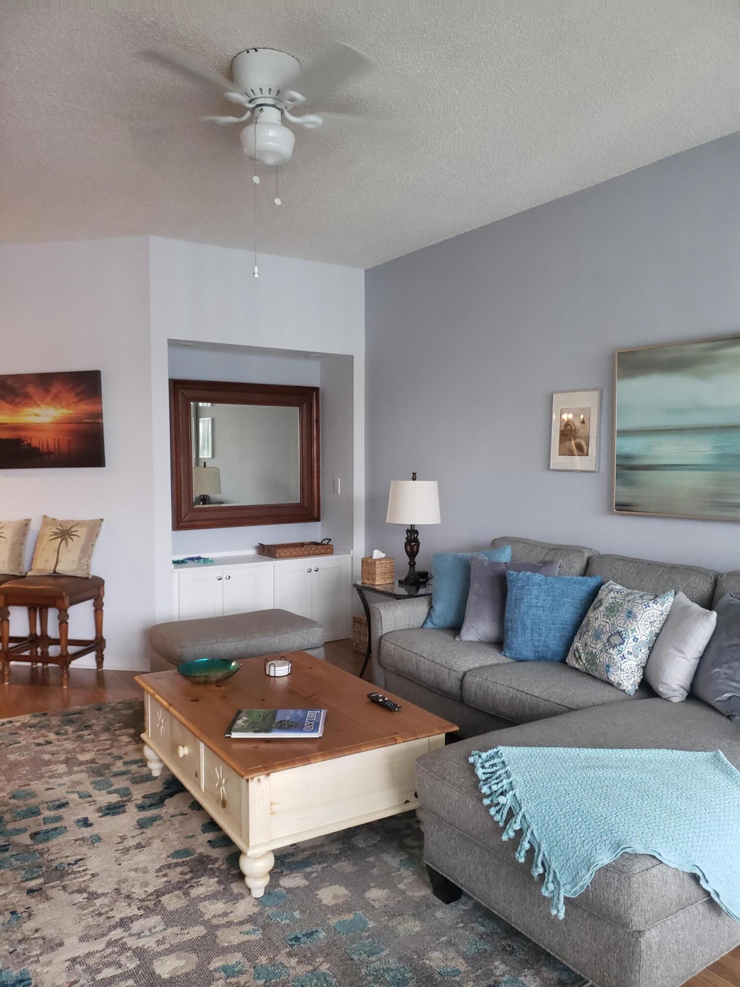 6021 Southeast Landing Way, Unit BLDG 2 #2 Stuart, FL 34997 - Photo 8 of 35 a living room with furniture and a flat screen tv