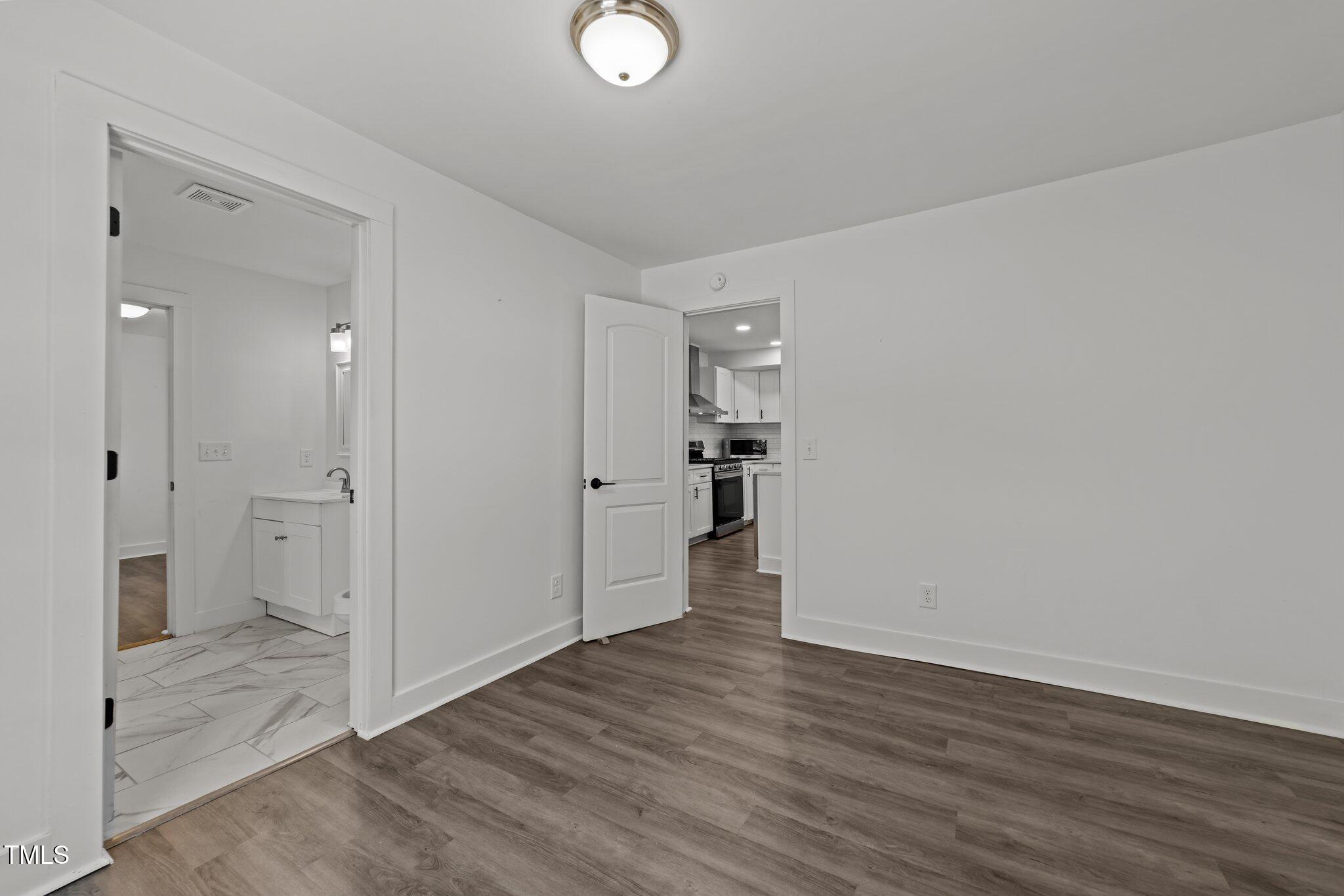 819 Cumberland Street Raleigh, NC 27610 - Photo 16 of 32 a view of empty room with wooden floor