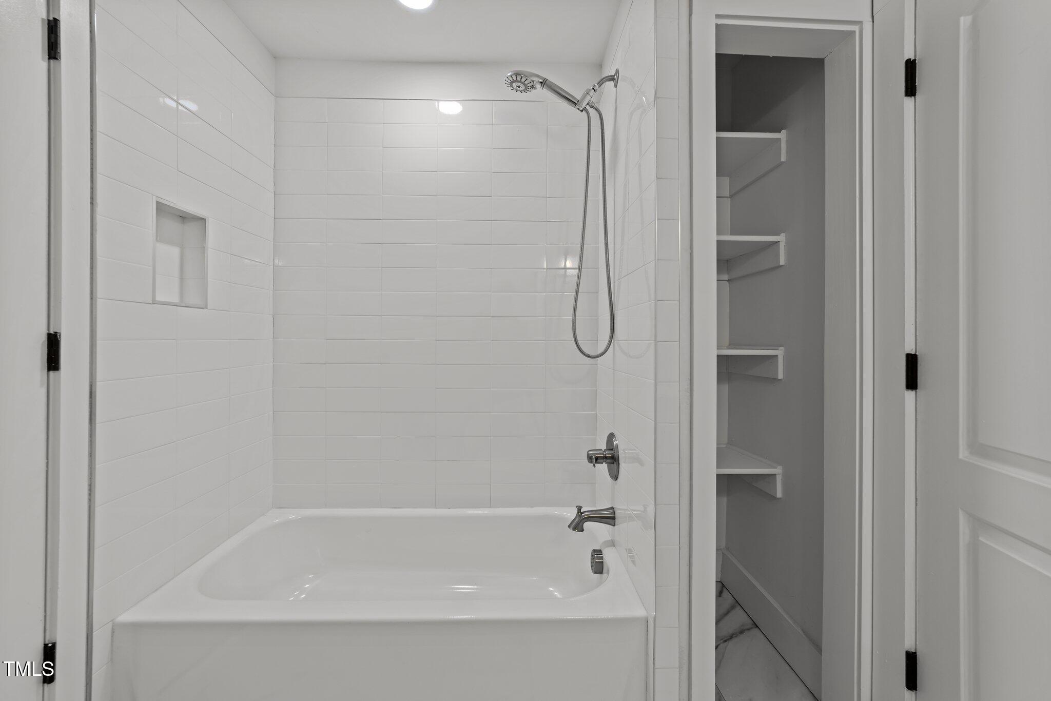 819 Cumberland Street Raleigh, NC 27610 - Photo 18 of 32 a bathroom with a shower and a bath tub