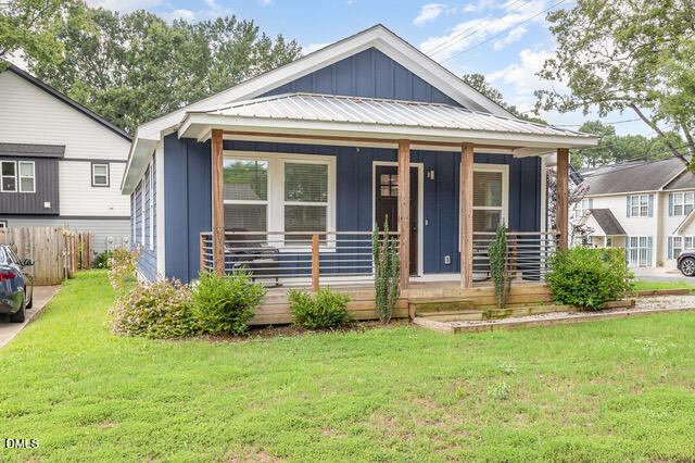 819 Cumberland Street Raleigh, NC 27610 - Photo 2 of 32 a front view of a house with a yard