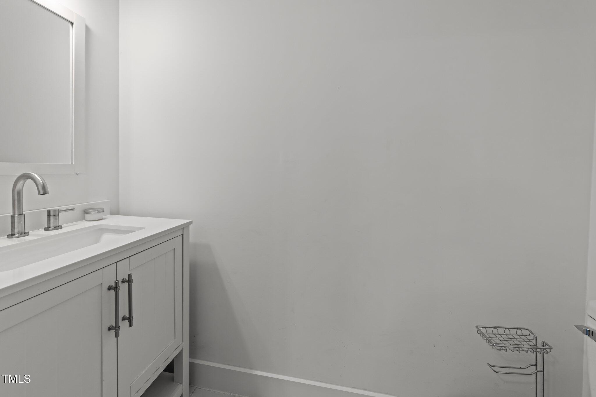 819 Cumberland Street Raleigh, NC 27610 - Photo 21 of 32 a bathroom with a sink and vanity
