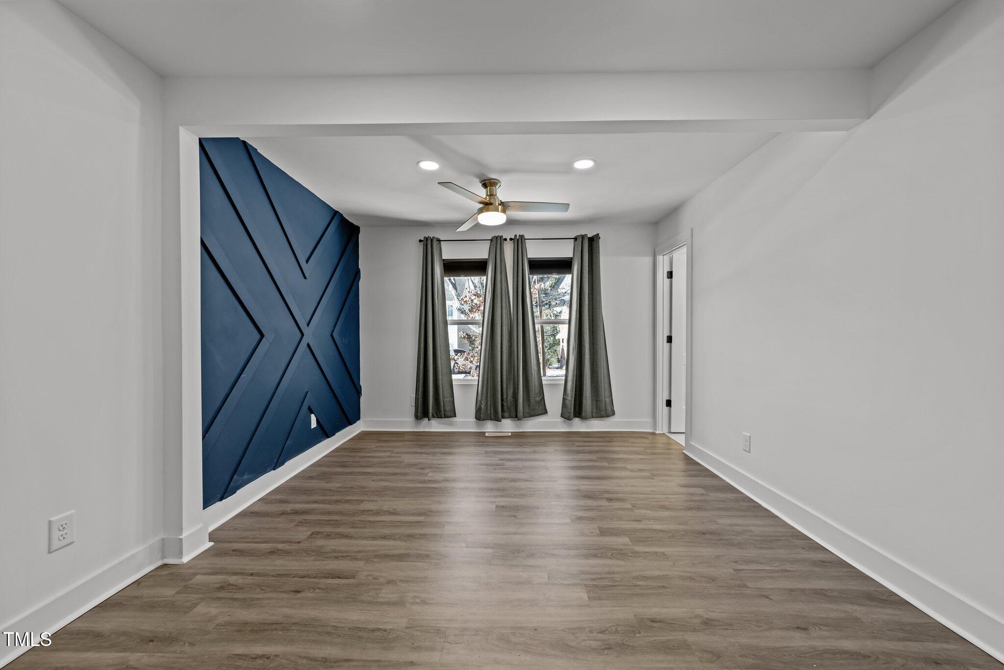 819 Cumberland Street Raleigh, NC 27610 - Photo 23 of 32 wooden floor in an empty room with a window