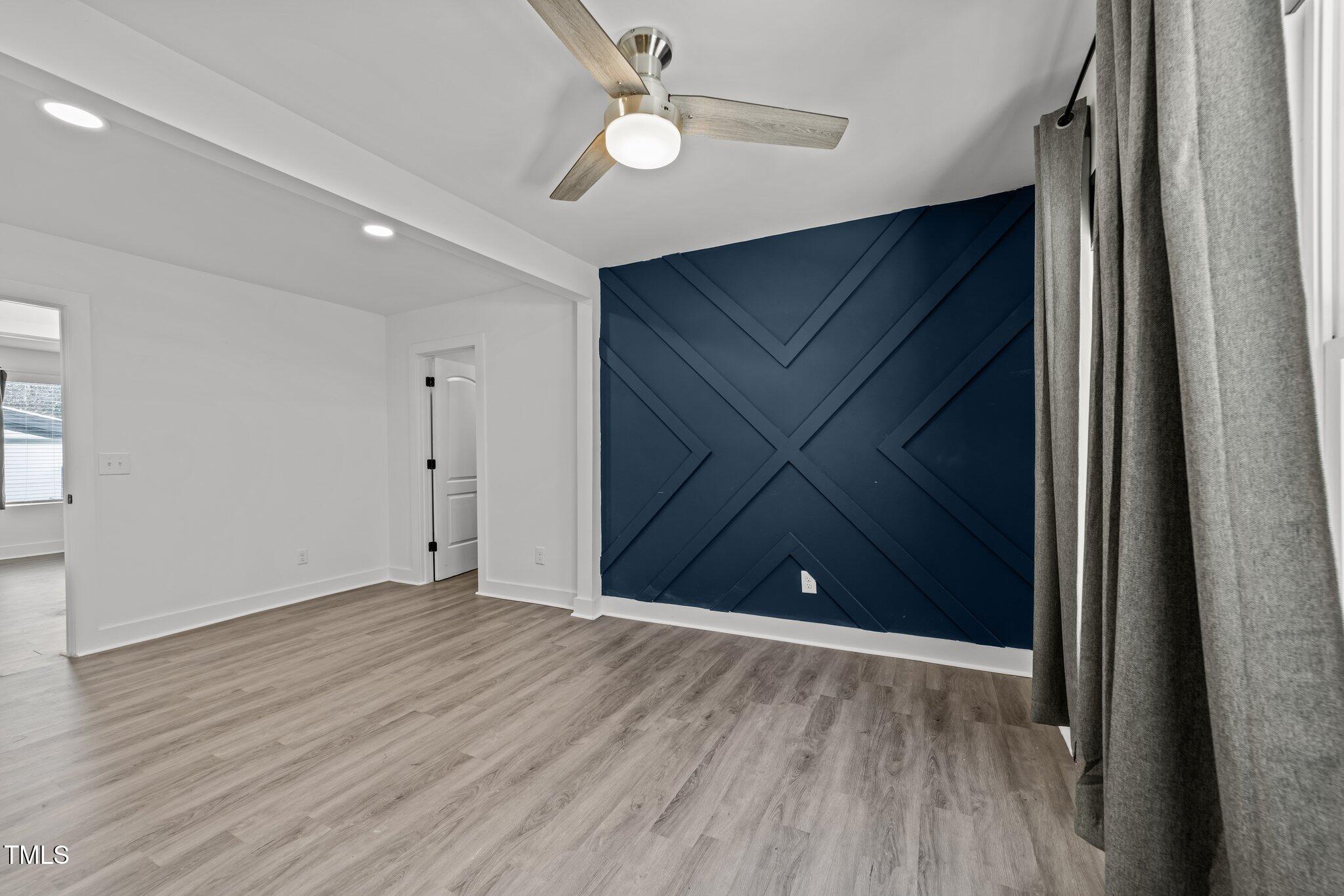 819 Cumberland Street Raleigh, NC 27610 - Photo 25 of 32 wooden floor in an empty room with a window