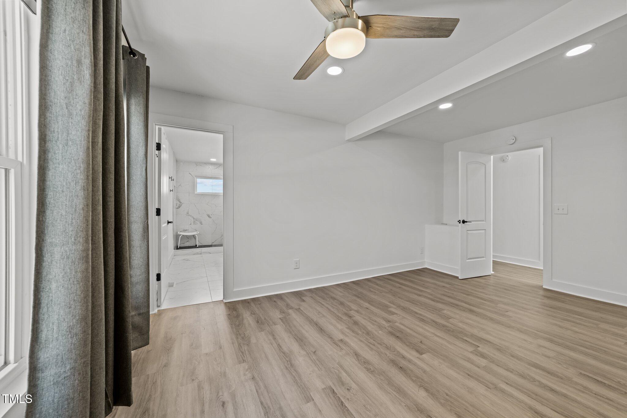 819 Cumberland Street Raleigh, NC 27610 - Photo 27 of 32 wooden floor in an empty room with a window