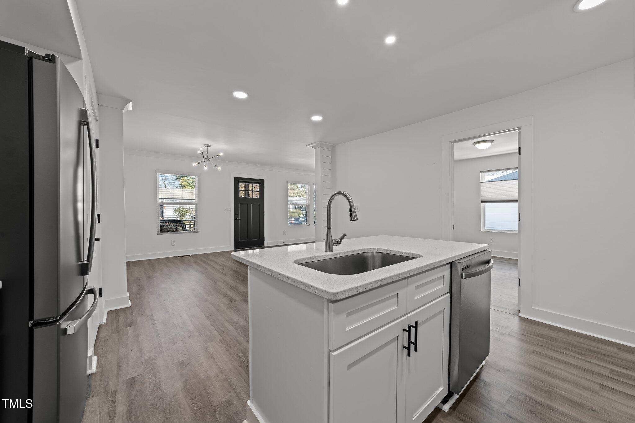 819 Cumberland Street Raleigh, NC 27610 - Photo 29 of 32 a kitchen that has a sink and a refrigerator