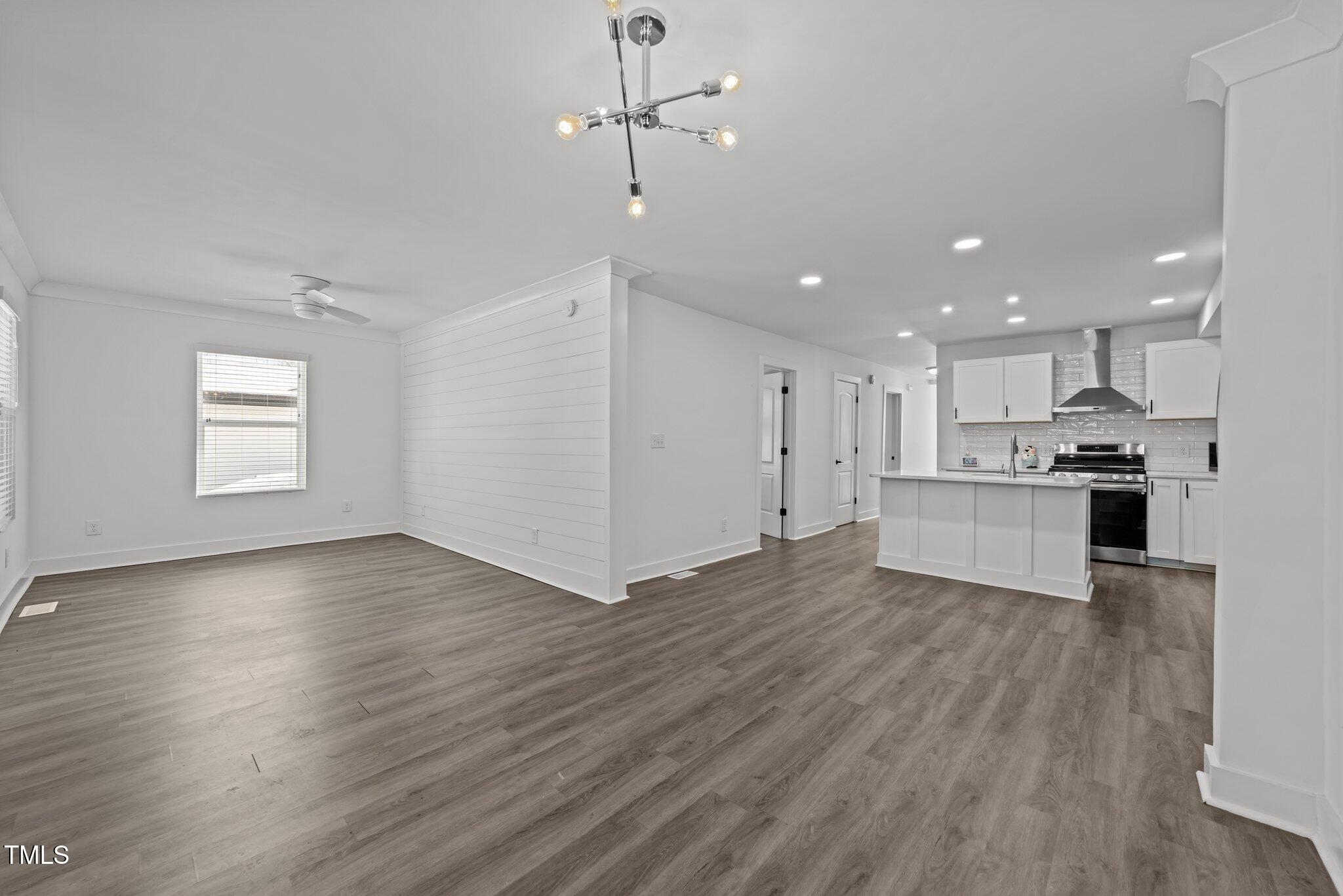 819 Cumberland Street Raleigh, NC 27610 - Photo 8 of 32 a view of kitchen with refrigerator stove and wooden floor