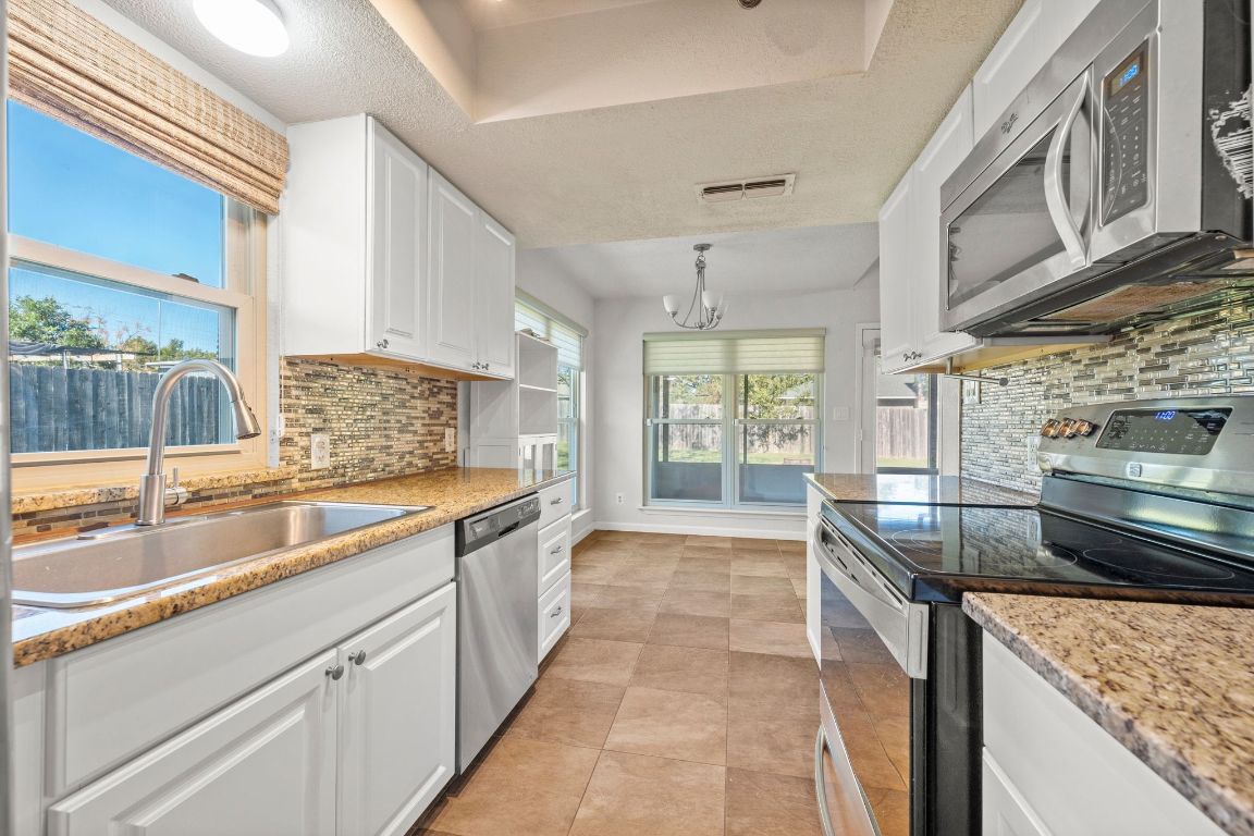 605 Apache Trail Leander, TX 78641 - Photo 12 of 27 a kitchen with a sink and a stove top oven