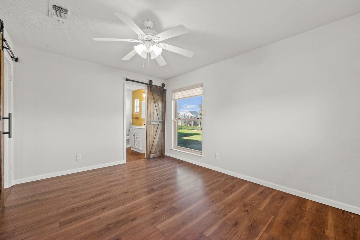 605 Apache Trail Leander, TX 78641 - Photo 14 of 27 wooden floor in an empty room with a window