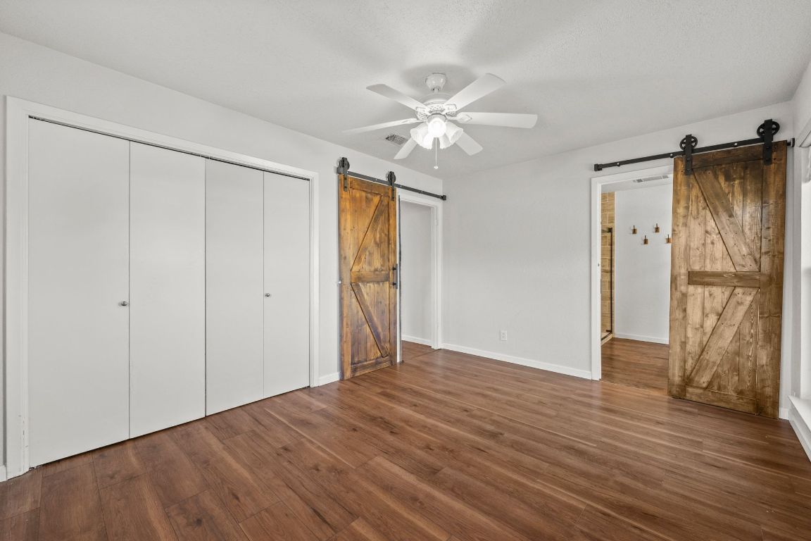 605 Apache Trail Leander, TX 78641 - Photo 15 of 27 a view of an empty room with wooden floor and a ceiling fan