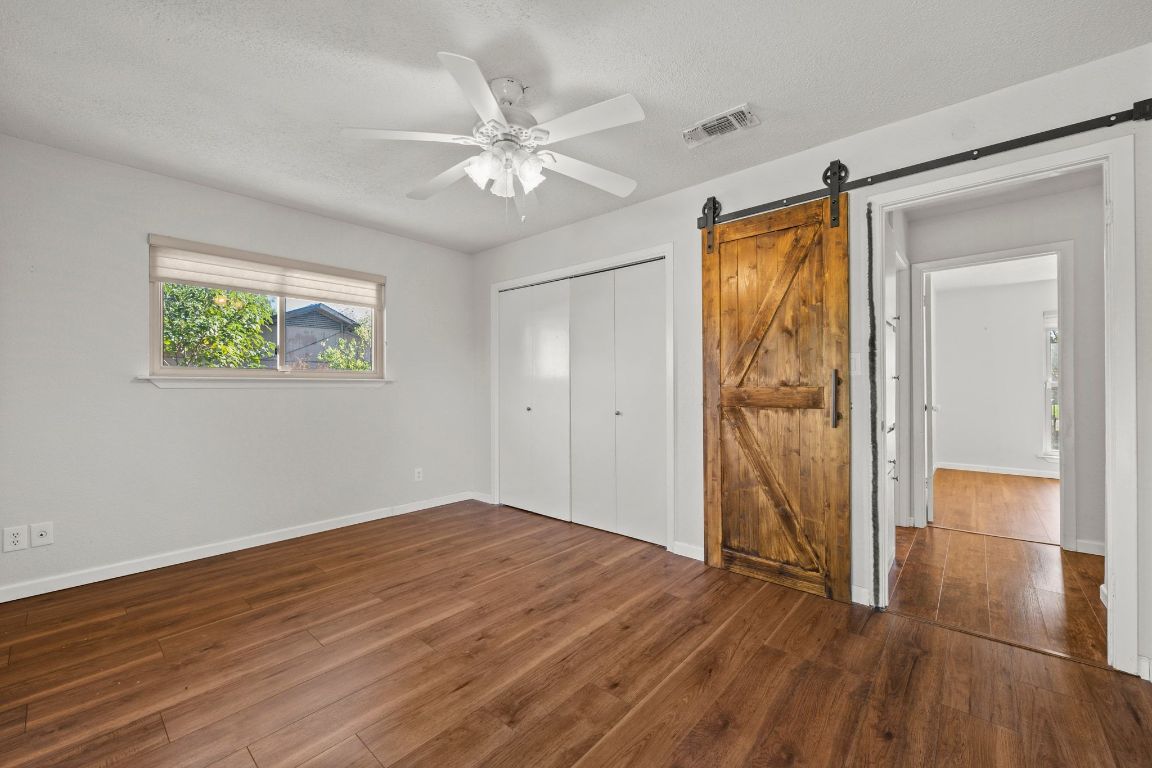 605 Apache Trail Leander, TX 78641 - Photo 16 of 27 a view of empty room with wooden floor and fan