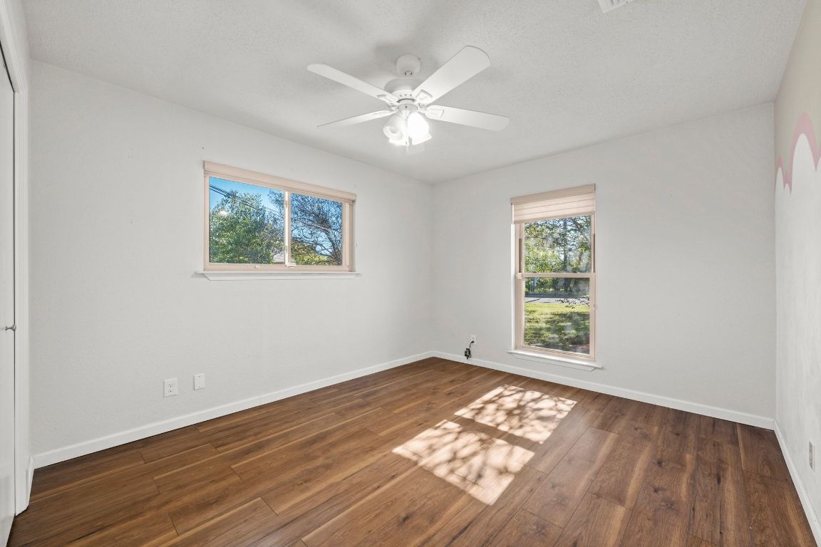605 Apache Trail Leander, TX 78641 - Photo 21 of 27 a view of an empty room with wooden floor and a window