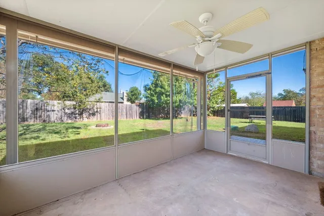 a view of room with window and ceiling fan