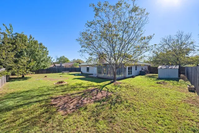 a view of a backyard with large trees