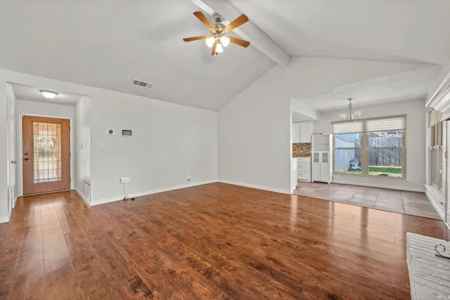 wooden floor in an empty room with a window