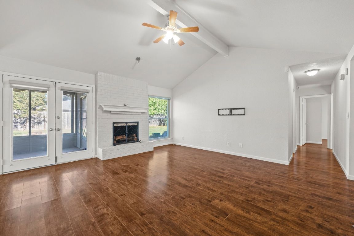 605 Apache Trail Leander, TX 78641 - Photo 6 of 27 a view of an empty room with window and wooden floor