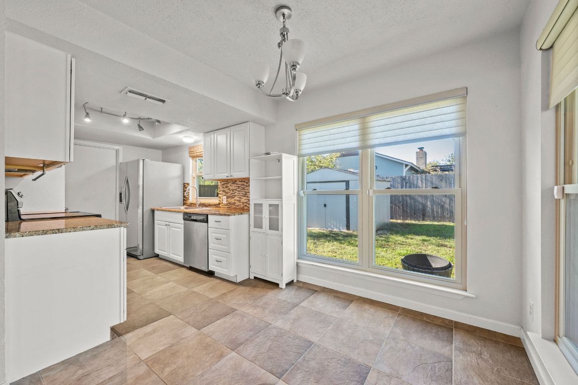 605 Apache Trail Leander, TX 78641 - Photo 8 of 27 a kitchen with refrigerator and window