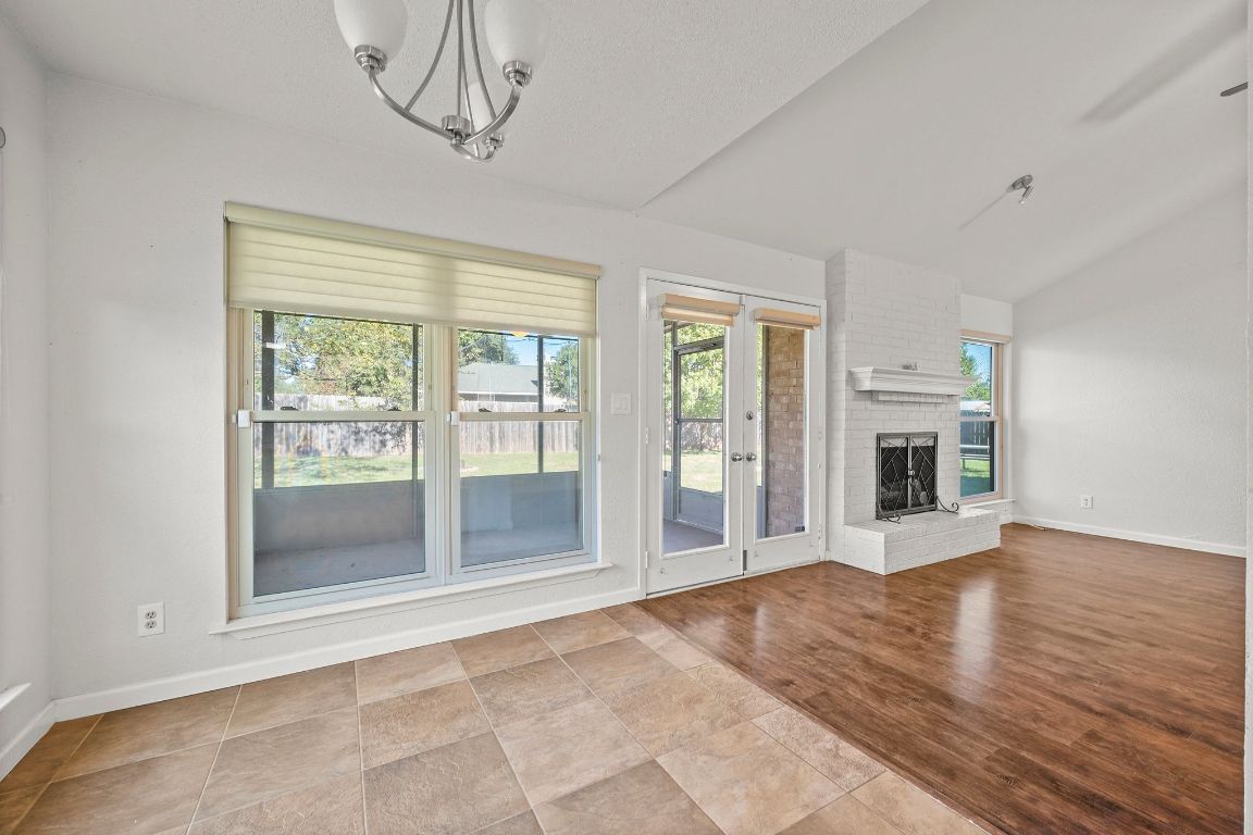 605 Apache Trail Leander, TX 78641 - Photo 10 of 27 a view of an empty room with a window and wooden floor