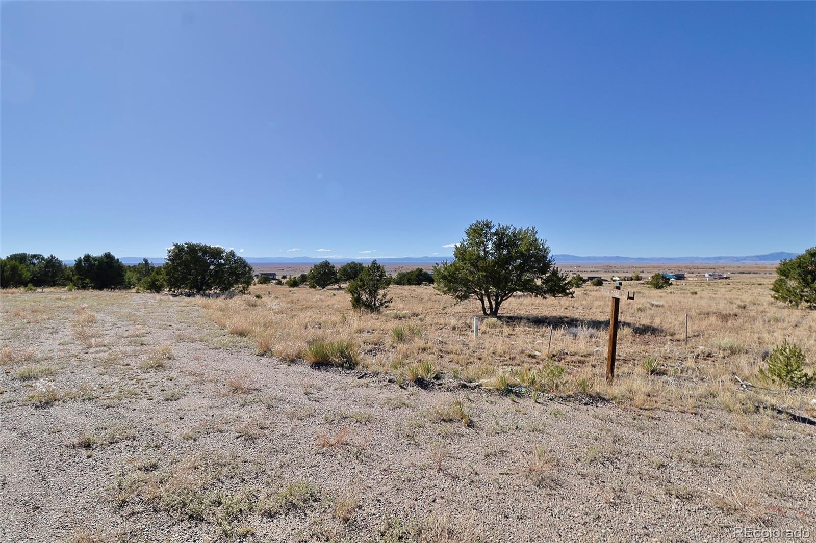 3402 Camino Del Rey Crestone, CO 81131 - Photo 3 of 14 a view of a dry yard with wooden fence