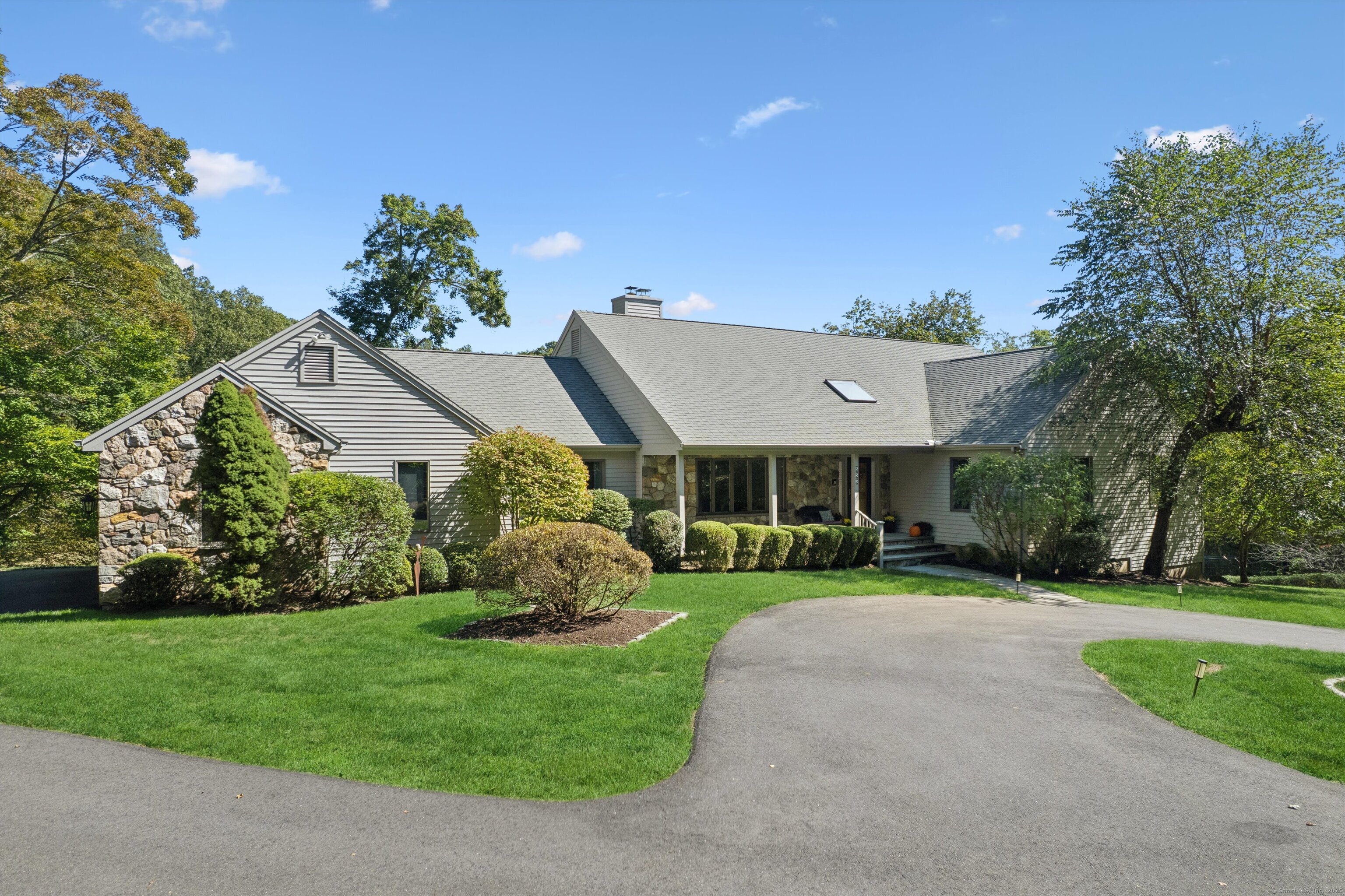 853 Riverbank Road Stamford, CT 06903 - Photo 1 of 1 a aerial view of a house with a yard and potted plants