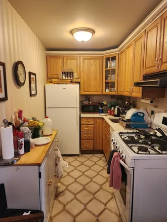 a kitchen with a sink a stove and a refrigerator