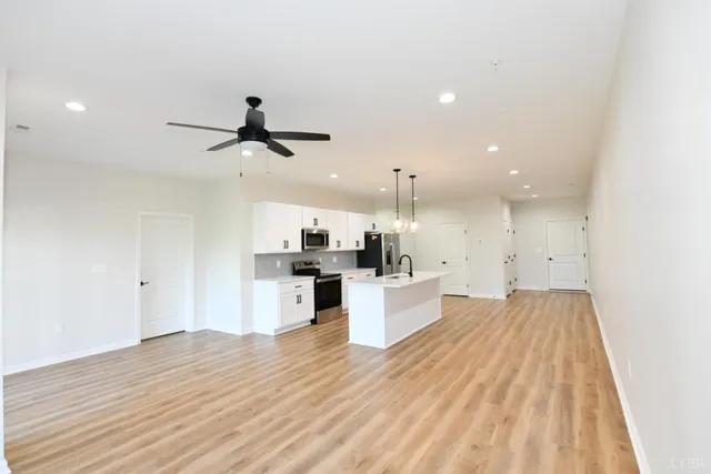 a view of kitchen with sink microwave and refrigerator