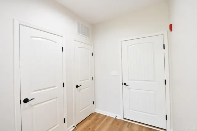 a view of a hallway with wooden floor