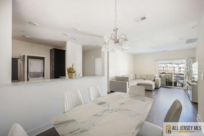 421 Tavern Road Monroe Township, NJ 08831 - Photo 11 of 27 a living room with furniture a large window and chandelier