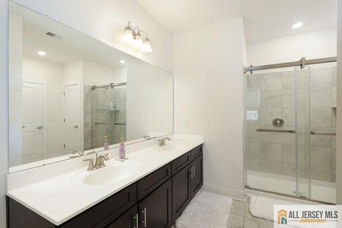 421 Tavern Road Monroe Township, NJ 08831 - Photo 19 of 27 a bathroom with a sink double vanity and shower