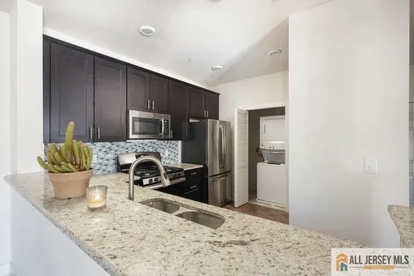 a kitchen with a stove and a refrigerator