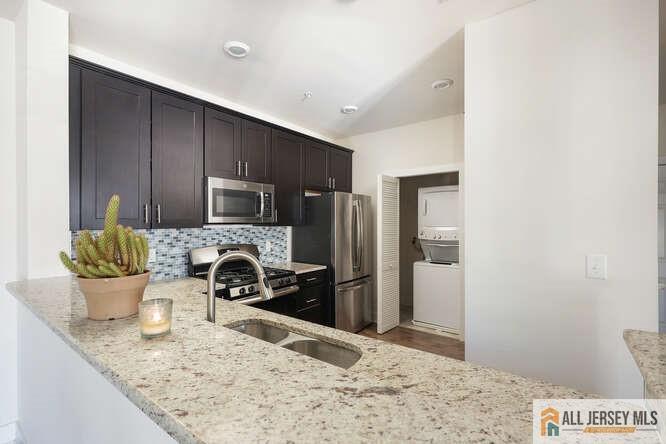 421 Tavern Road Monroe Township, NJ 08831 - Photo 8 of 27 a kitchen with a stove and a refrigerator