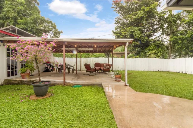 a view of a patio with table and chairs potted plants with wooden fence