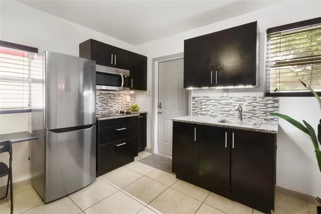 a kitchen with a refrigerator and a microwave