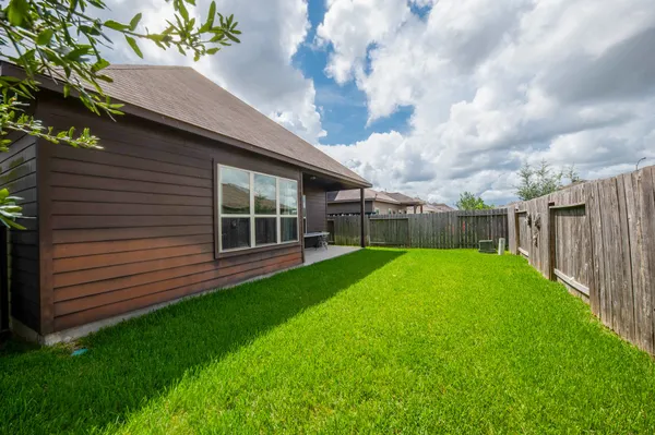 a view of a house with a yard and sitting area