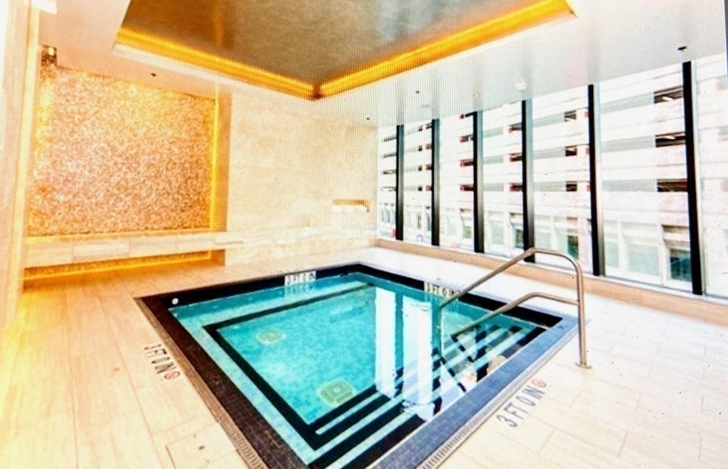 1 Franklin Street, Unit 1205 Boston, MA 02110 - Photo 11 of 16 a view of a living room and a balcony