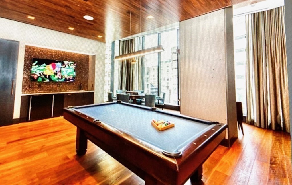 1 Franklin Street, Unit 1205 Boston, MA 02110 - Photo 13 of 16 a room with pool table and windows