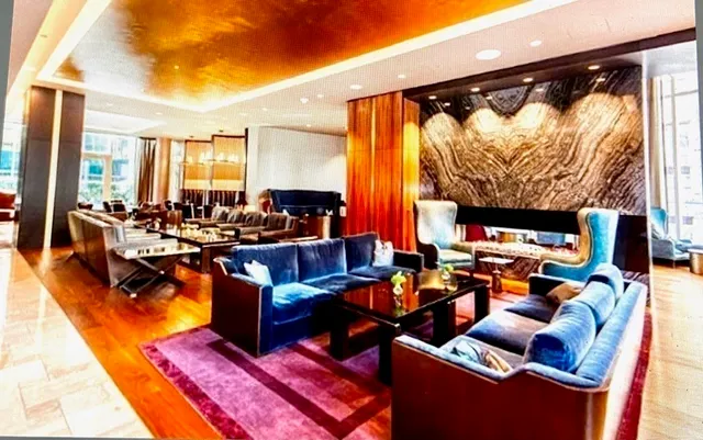 a living room with furniture and a floor to ceiling window