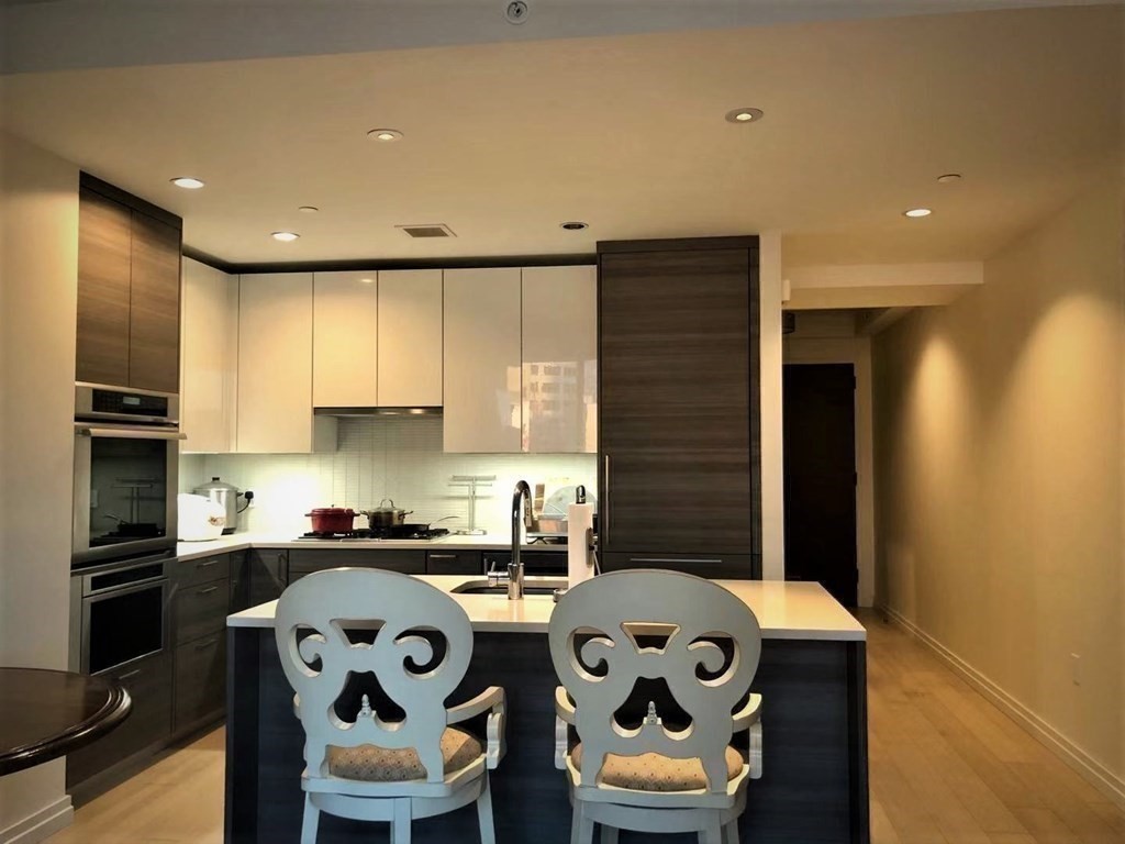 1 Franklin Street, Unit 1205 Boston, MA 02110 - Photo 3 of 16 a kitchen with a sink a stove and cabinets